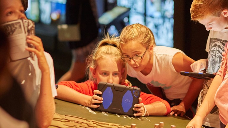 Primary school students participating in the 'Our Shared History' program in the First Peoples exhibition, Bunjilaka, Melbourne Museum. 