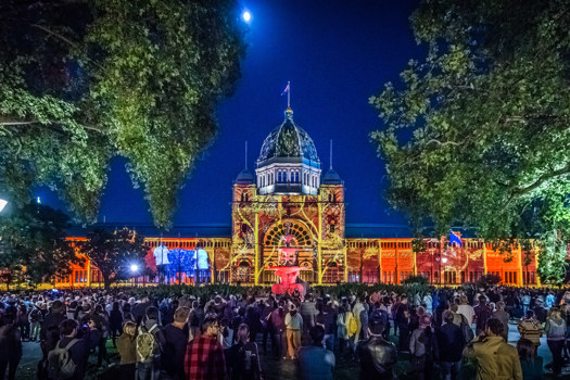Crowd watching light projection on building