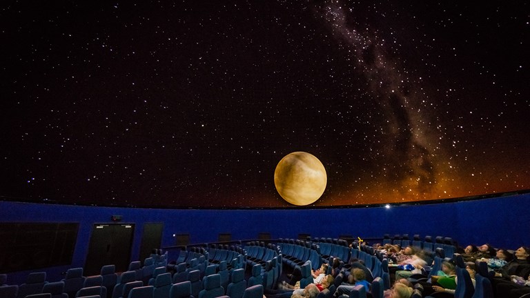 People viewing a show in the planetarium