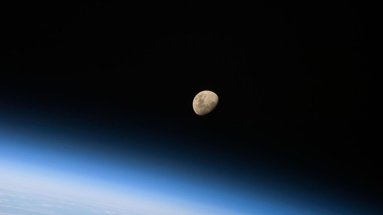 Photograph of the moon above the earth