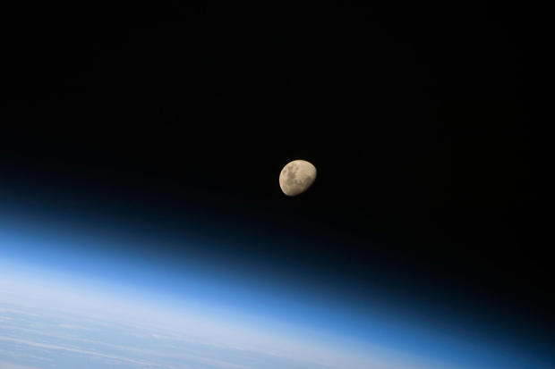 Photograph of the moon above the earth
