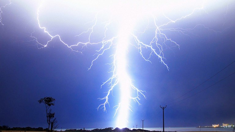 A lightning strike illuminates the sky near the Thevenard silos at Ceduna, South Australia. 