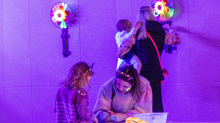 Children with adults exploring the Glow Lab activity held in the Energy Lab, during the 'Little Kids day In - Ready, Set, Glow' event at Scienceworks.