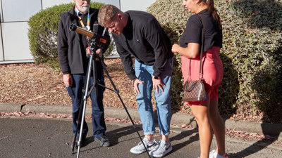 People enjoying the Valentine's Day themed events at Scienceworks, with staff providing a view of the skies with telescope.