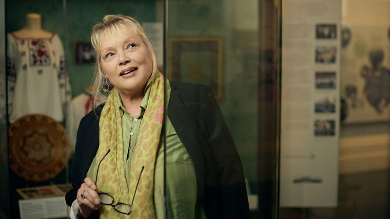 A woman looks at displays in Voices Across Time exhibition in the Immigration Museum.