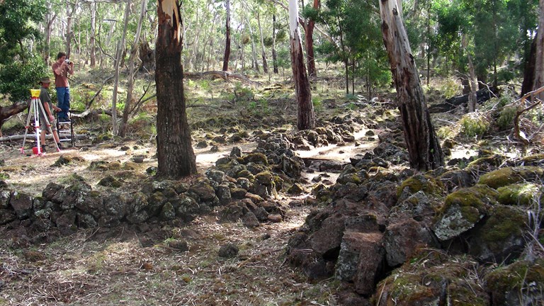 Man photographing rock formations in bushland