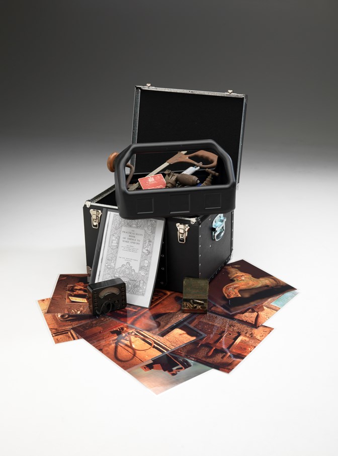 Box of hand tools with supporting pictures used in outreach programs 