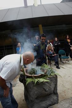 Two men creating smoke for ceremony
