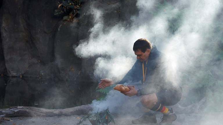 Man squat partially enclosed in smoke