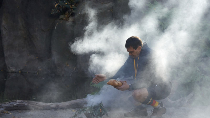 Man squat partially enclosed in smoke