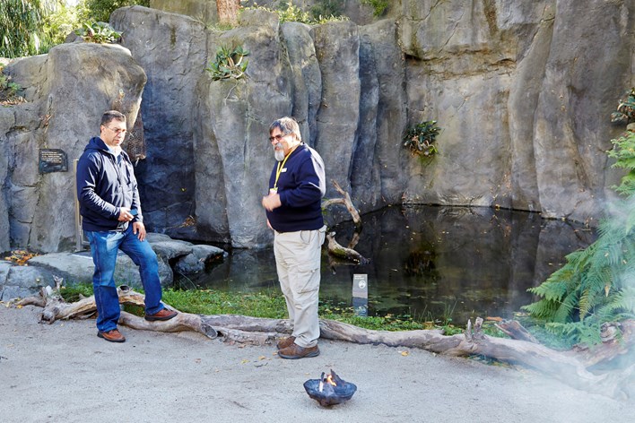 Two men standing beside Milarri Pond