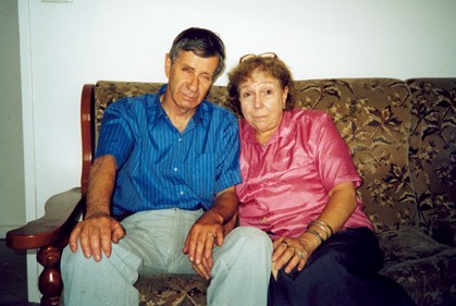 A woman and man sitting on a couch