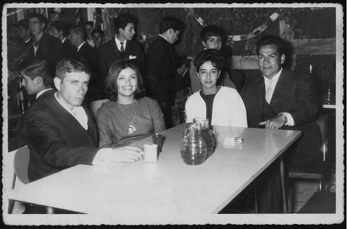 Black and white image of a group of people sitting at a table