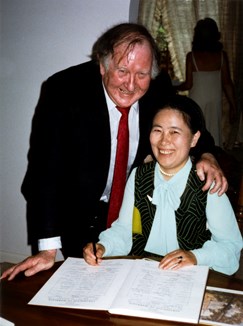 Man and woman signing a document