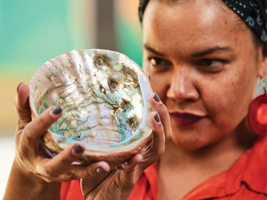 A museum worker inspects a specimen.