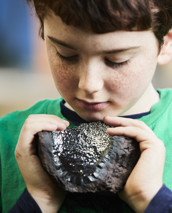 Boy holding a rock specimen