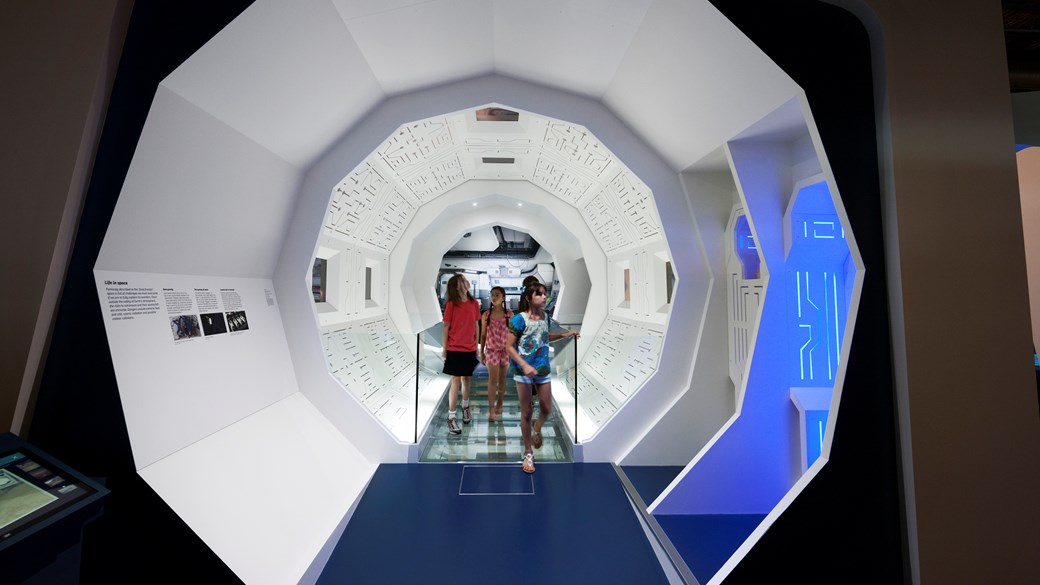 Children walking through a futuristic hallway at the Scienceworks Museum