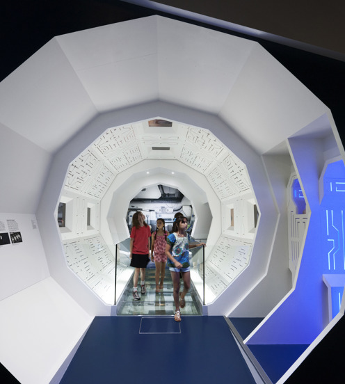 Children walking through a futuristic hallway at the Scienceworks Museum