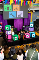  Families engaging with the Robo-Boogie activity in the Amphitheatre during Little Kids Day In program at Scienceworks