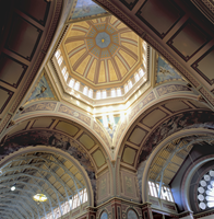 A view of a decorative ceiling from below looking up.