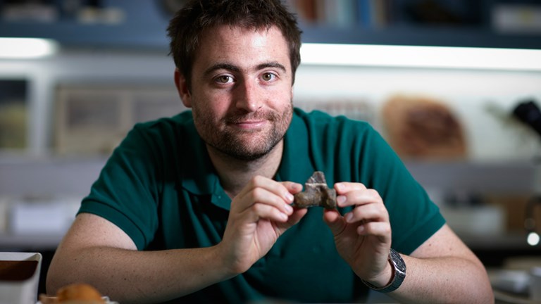 Man holding a fossil