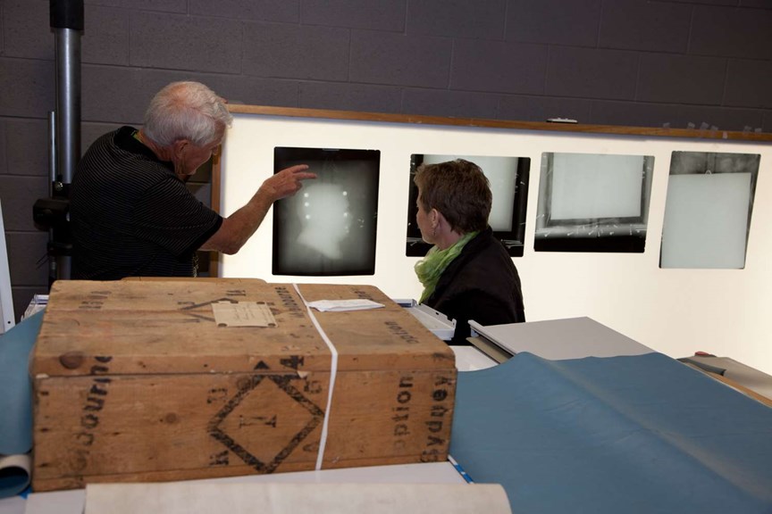 Two people examining x-rays