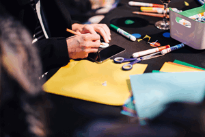 Adults at Nocturnal enjoying a crafting activity.