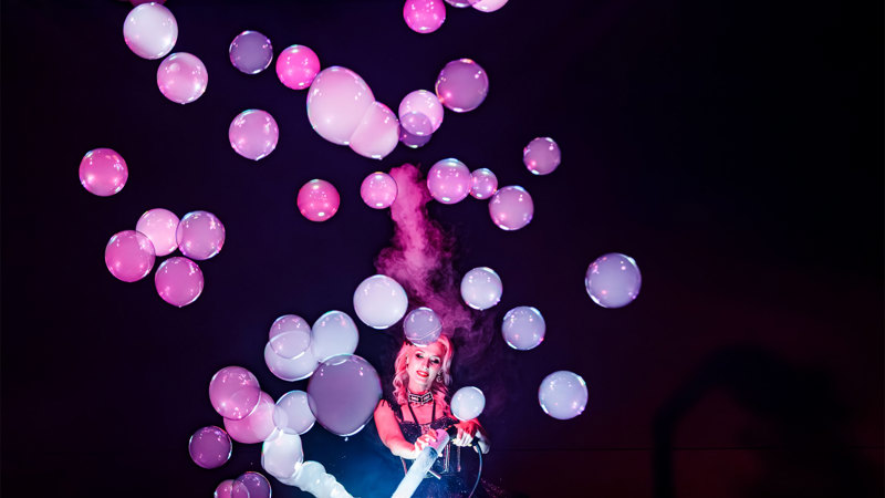 Becky Bubbles making smoke filled bubbles during her Magic Noir performance.