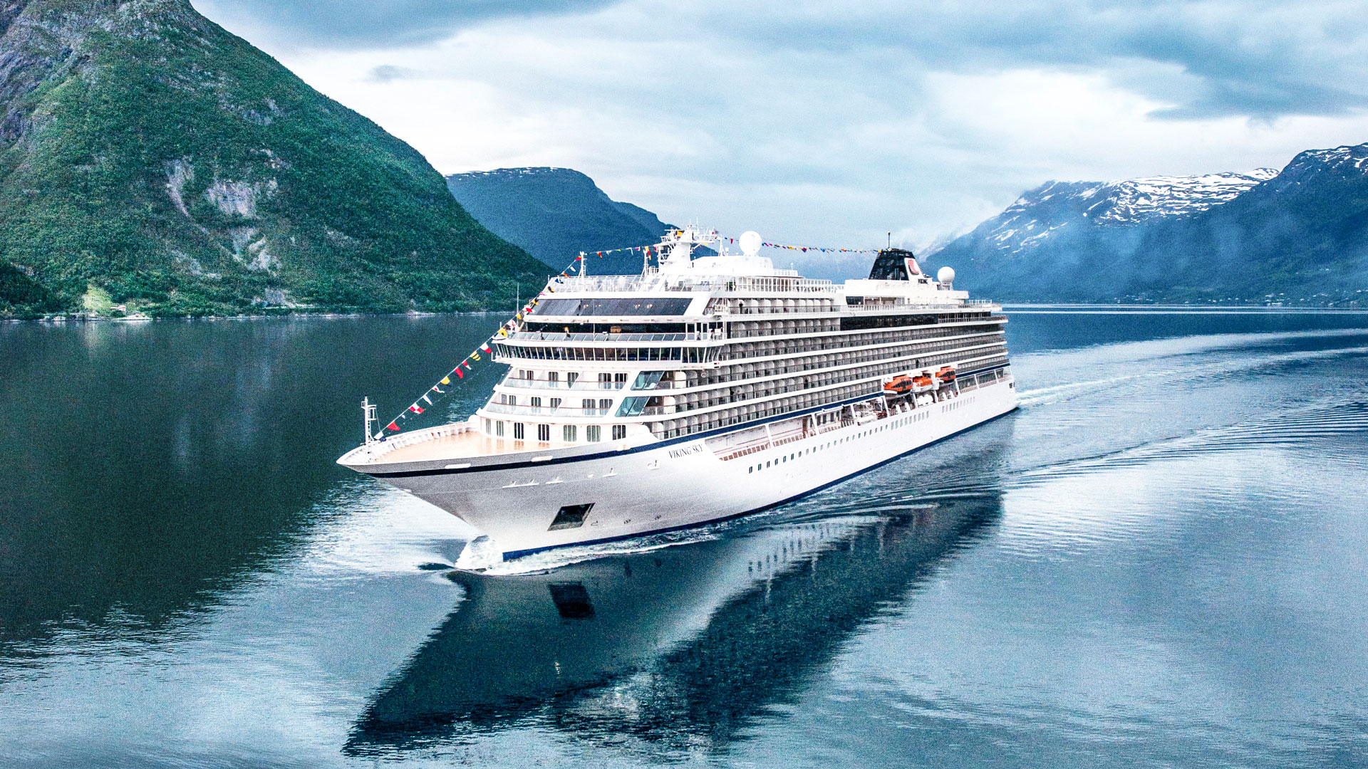 Cruise ship with snowcapped mountains in the background