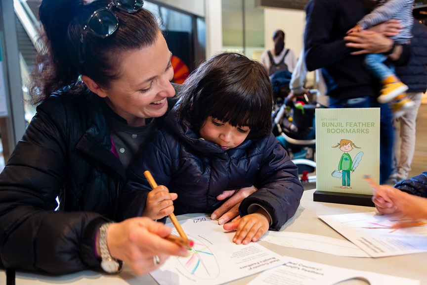 Family making their own Bunjil Feather Bookmark at Melbourne Museum. 
