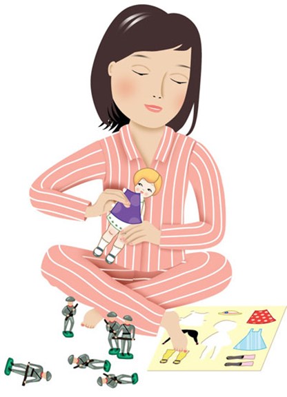 Girl playing with paper dolls