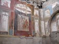 Fresco depicting three gods on an interior wall