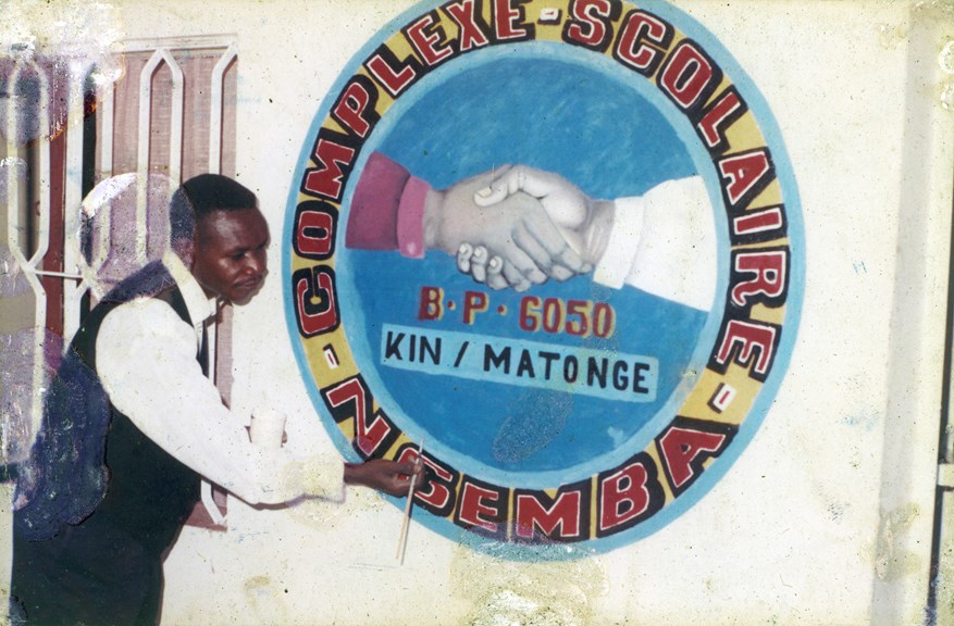 Nickel Mundabi painting a harmony mural at Ngemba School, where he taught art. The school is in the Matonge district of Kinshasa the capital city of the Democratic Republic of Congo.