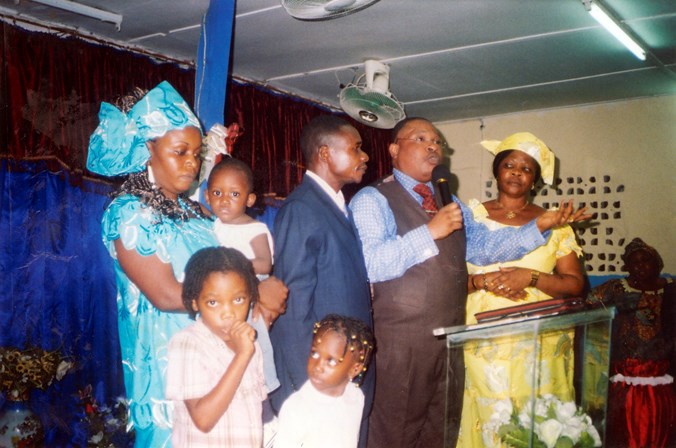 Mundabi family farewell and blessing at their church in Cameroon.