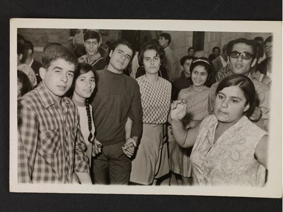 Group portrait and a woman dancing dabke in Hadchit, ca. 1968.