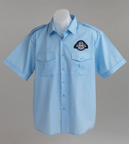 Blue short sleeved shirt with emblazoned Silver Top Taxi logo.