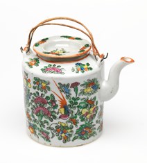 Part of a traditonal chinese tea set consisting of a ceramic tea pot, lid and two cups contained in a lined and padded woven rattan basket, possibly late nineteenth century.