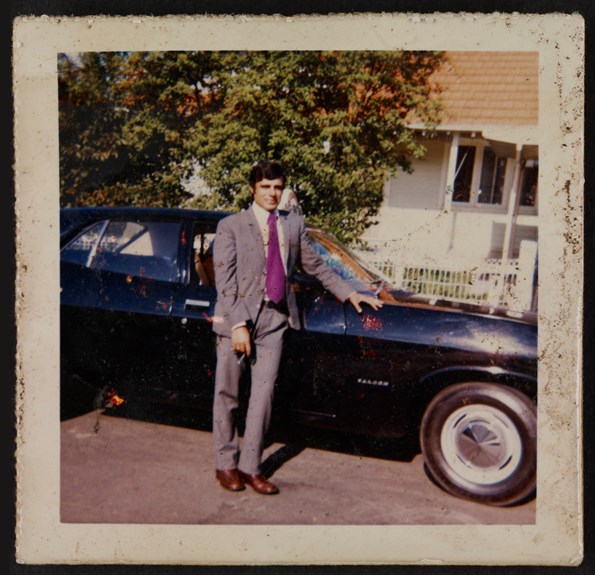 Portrait of man in front of a taxi, 1974. 