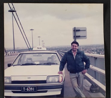 Portrait of taxi driver in front of his taxi on Westgate bridge, 1985.