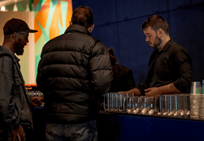 People grabbing drinking and food from the bar at Nocturnal, Melbourne Museum.