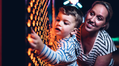 Woman and young child using interactive in the exhibition