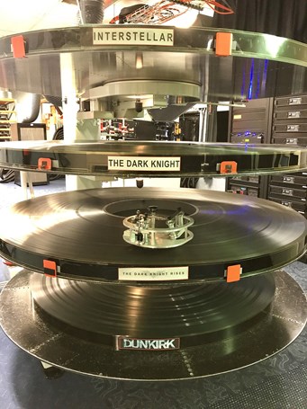 Spooled up reels of the films Interstellar, The Dark Knight, The Dark Knight Rises and Dunkirk ready to be used.