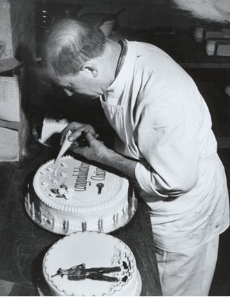 Karl Muffler decorating a congratulatory cake at 'Paterson's Cake Shop', 1970s.