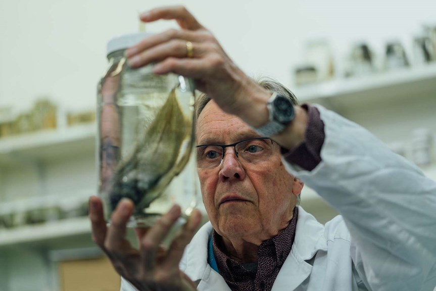 Scientist with specimen in jar