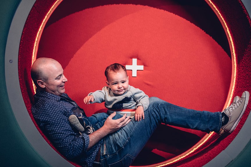 Father and child play inside children's gallery Ground Up: Building Big Ideas, Together at Scienceworks.