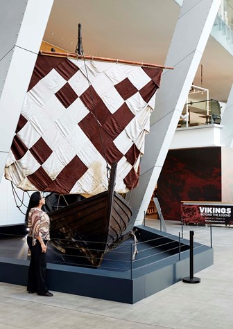 Visitor looking at the Krampacken, a replica of a Viking merchant boat.