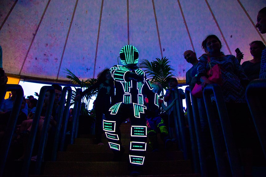 Man dressed as a robot, covered in green lights, performing at the Museum Members' 2018 Summer Party at Scienceworks.