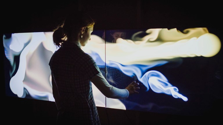 Member of JBoard engaged in testing new exhibits for Beyond Perception: Seeing the Unseen.