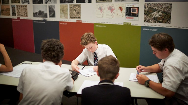 A groups of students working around a desk