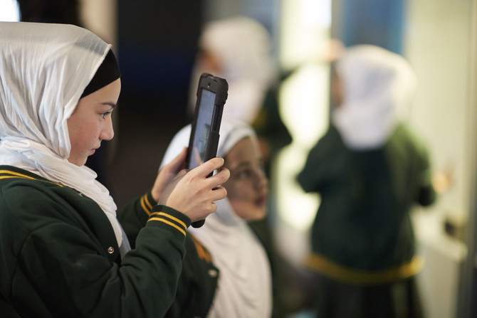 Student holding up iPad